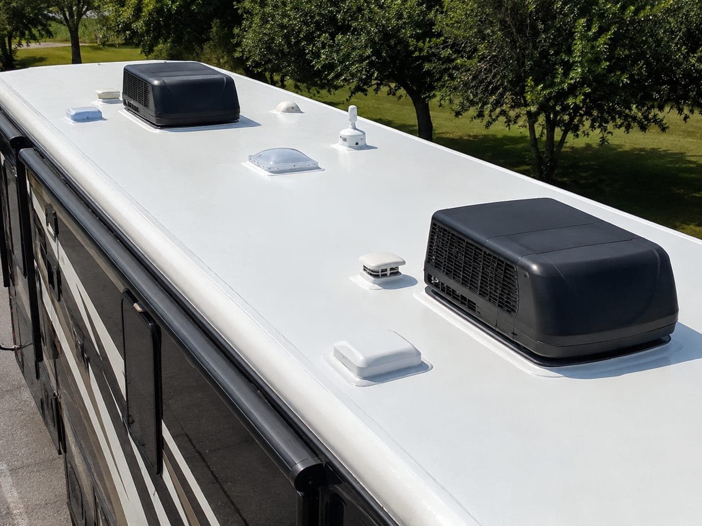 Freshly resealed seam and vent on the white TPO roof of an American RV