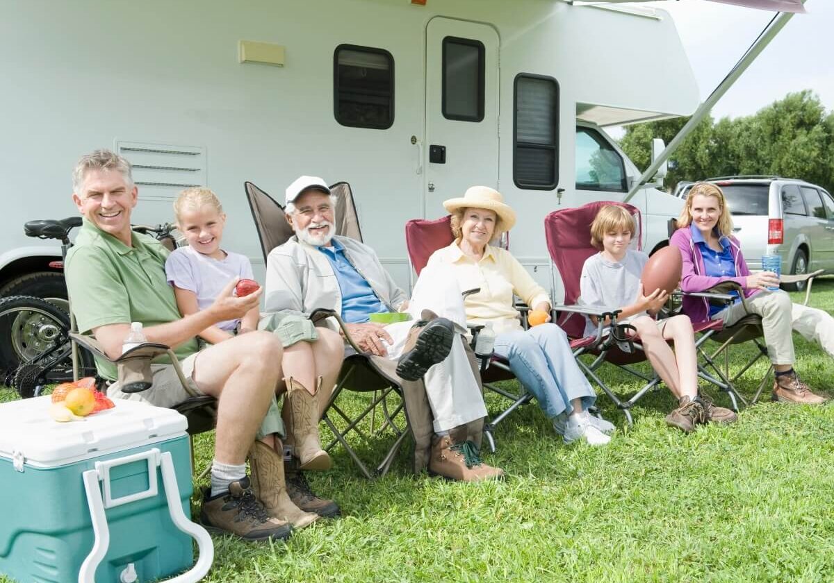 Happy Family Sitting Outside RV